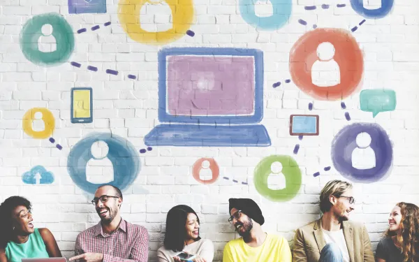 computer icon linked to people icons with actual people communicating face-to-face